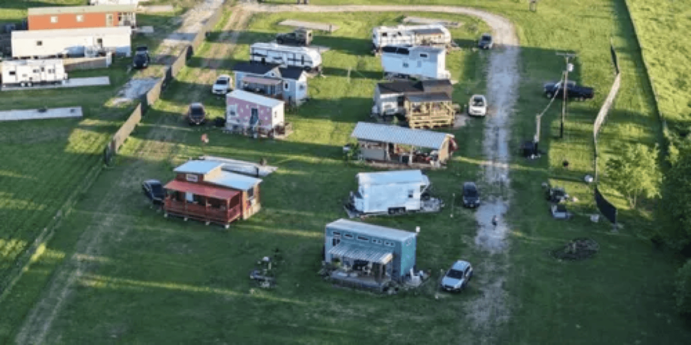 Concrete THOW pads and communal outdoor kitchen at The Bird's Nest Tiny Living Community in Cumby, Texas.
