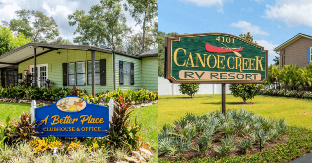 Paved neighborhood street lined with neat park-model homes with carports and green lawns under a blue sky.