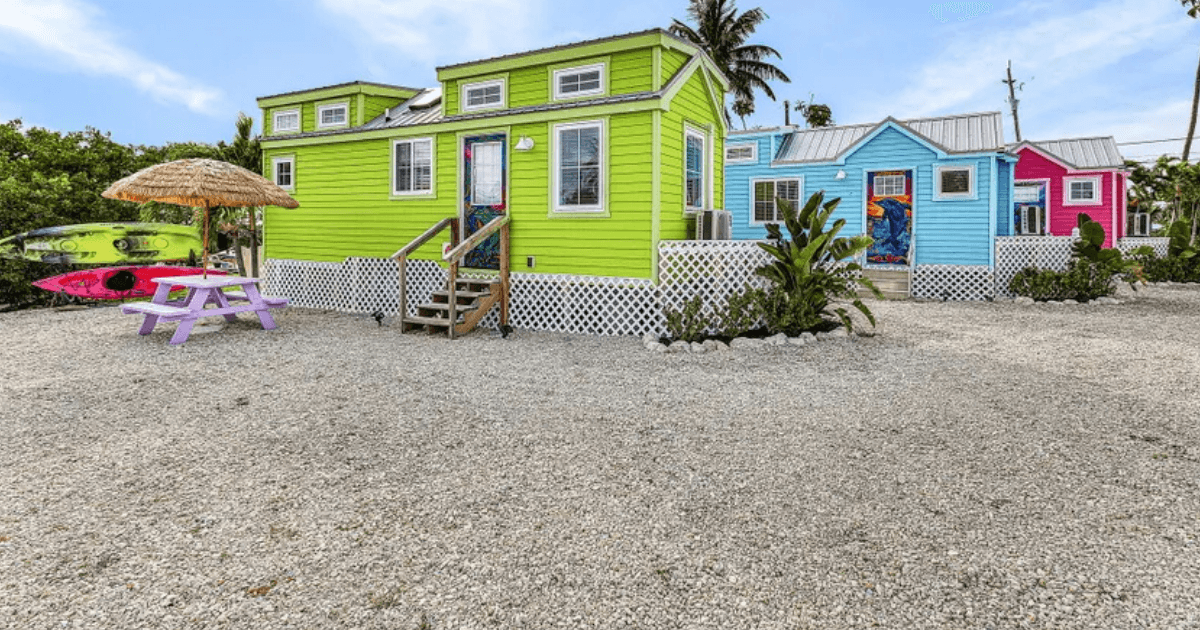 Colorful cottages along coastal water.